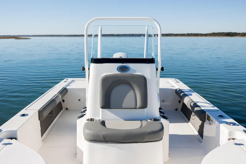 Slide: The Image of 2024 Sea Born FX22 Bay boat on calm water, showcasing sleek design and seating. - 19