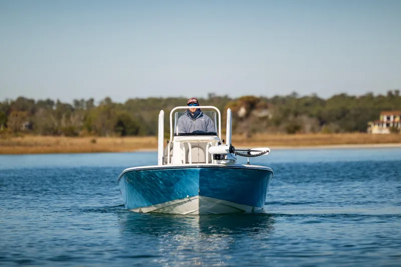 Slide: The Image of 2024 Sea Born FX22 Bay boat cruising on calm water. - 2