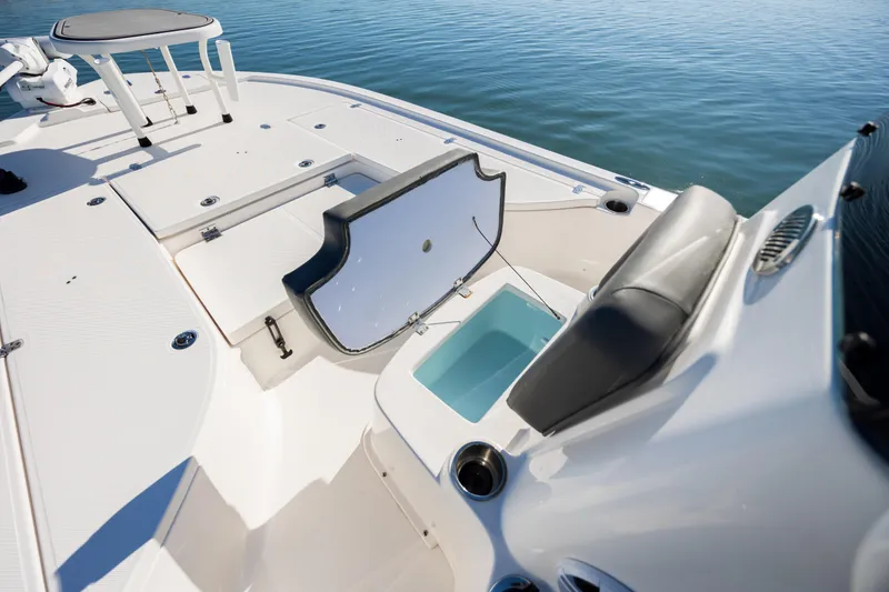 Slide: The Image of 2024 Sea Born FX22 Bay boat interior with open storage compartment and seating. - 20