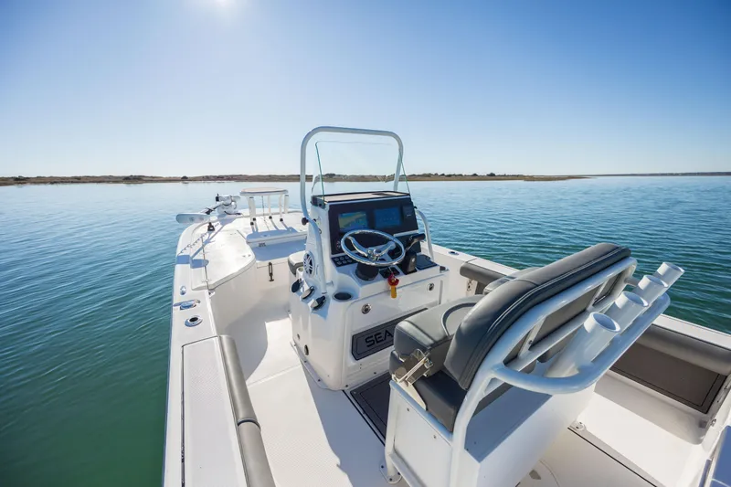 Slide: The Image of 2024 Sea Born FX22 Bay boat on calm water, featuring sleek design and modern controls. - 23