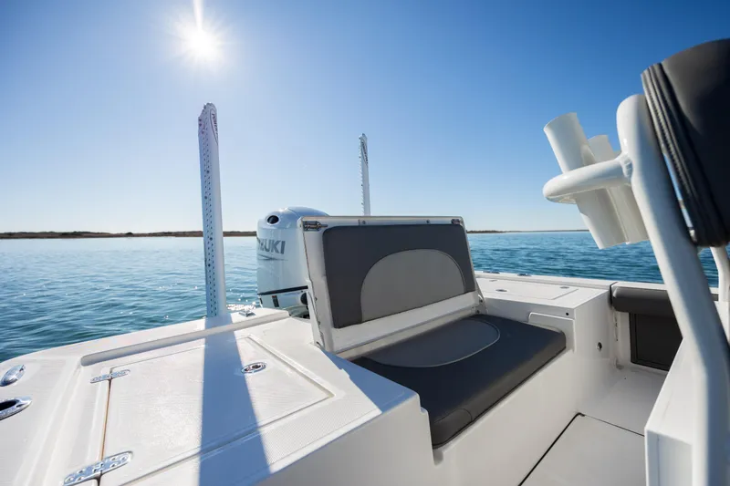 Slide: The Image of 2024 Sea Born FX22 Bay boat on calm water under clear blue sky. - 25