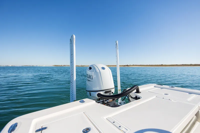 Slide: The Image of 2024 Sea Born FX22 Bay boat on calm water with Suzuki outboard motor. - 26