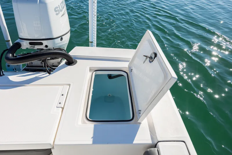 Slide: The Image of 2024 Sea Born FX22 Bay boat with open storage compartment on calm water. - 28