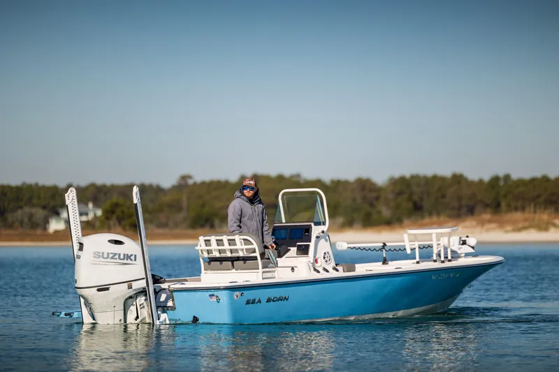 Slide: The Image of 2024 Sea Born FX22 Bay boat with Suzuki engine on calm water. - 6