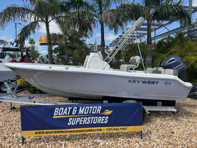 Slide: The Image of 2025 Key West 189 FS boat displayed at Boat & Motor Superstores, surrounded by palm trees. - 1