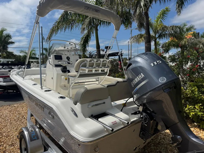 Slide: The Image of 2025 Key West 189 FS boat with Yamaha 115 engine, parked outdoors. - 12