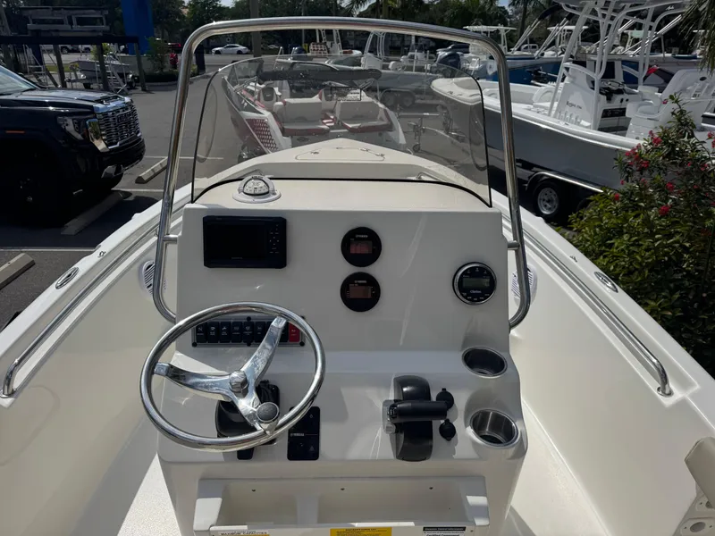 Slide: The Image of 2025 Key West 189 FS boat dashboard with steering wheel and controls. - 19