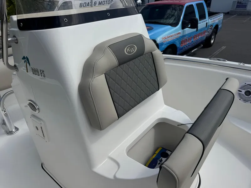 Slide: The Image of 2025 Key West 189 FS boat interior with cushioned seating and storage compartment. - 27
