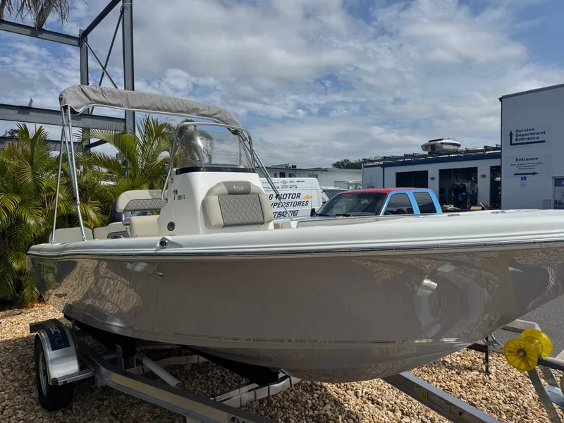 Slide: The Image of 2025 Key West 189 FS boat on trailer, parked outdoors under cloudy sky. - 4