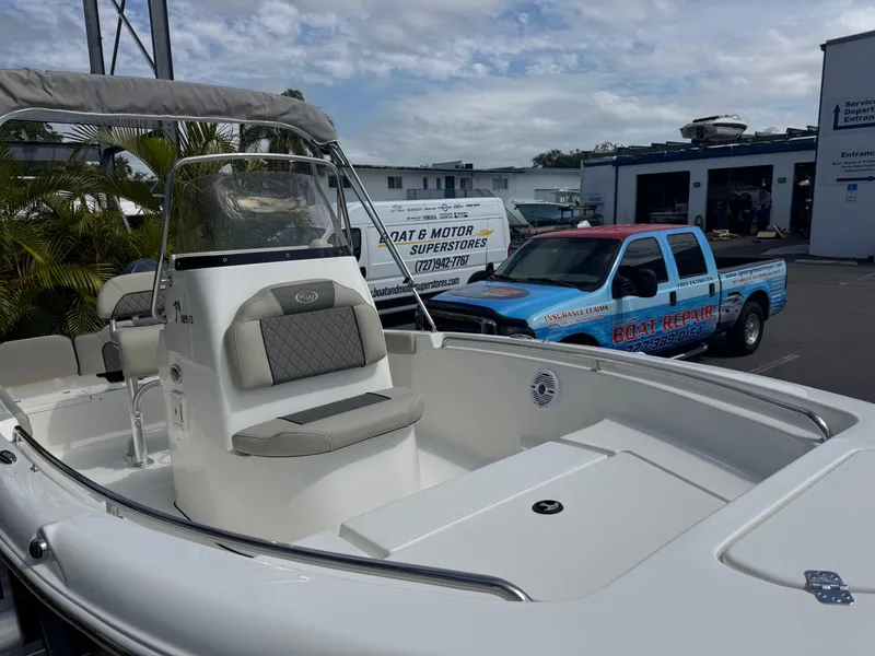 Slide: The Image of 2025 Key West 189 FS boat with seating, parked near a blue truck. - 5