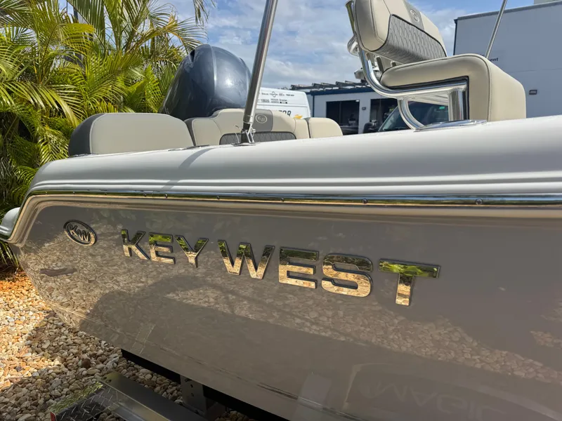 Slide: The Image of 2025 Key West 189 FS boat, side view with logo, outdoor setting. - 7