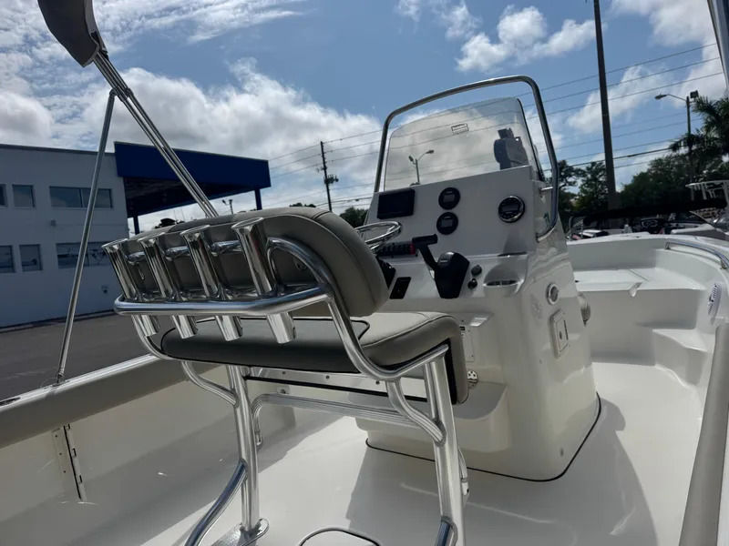 Slide: The Image of 2025 Key West 189 FS boat interior with console and seating under a partly cloudy sky. - 9