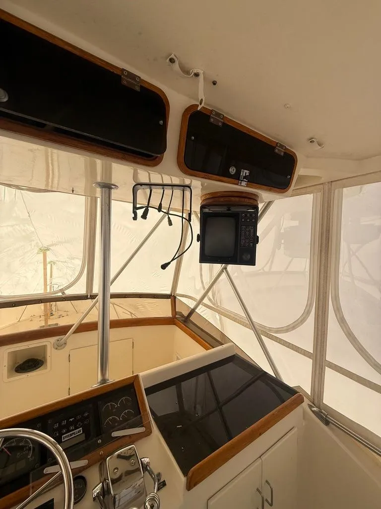 Slide: The Image of 1989 Post 43 Sport Fisherman boat interior with navigation equipment and control panel. - 10