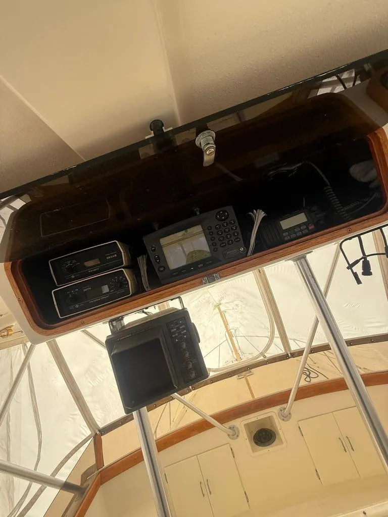 Slide: The Image of 1989 Post 43 Sport Fisherman boat cockpit with navigation equipment and controls. - 11