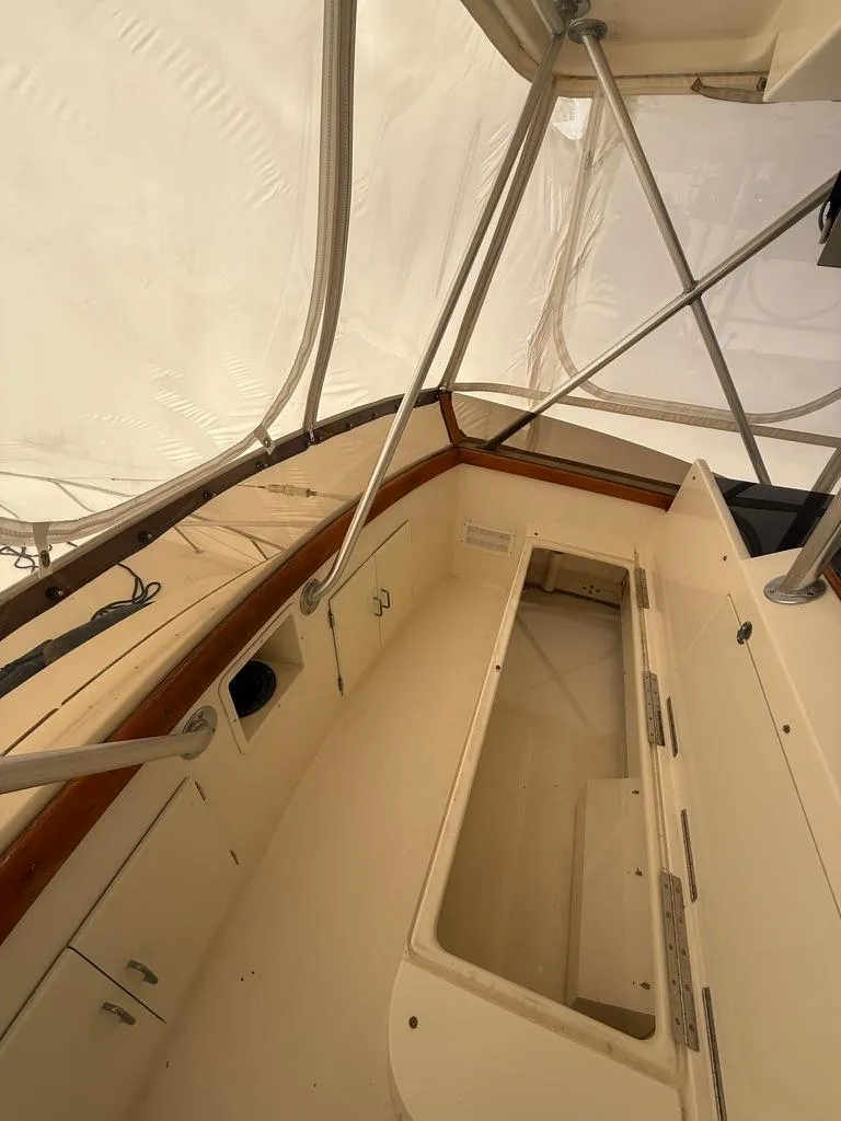 Slide: The Image of 1989 Post 43 Sport Fisherman boat interior with storage compartments and railing. - 12