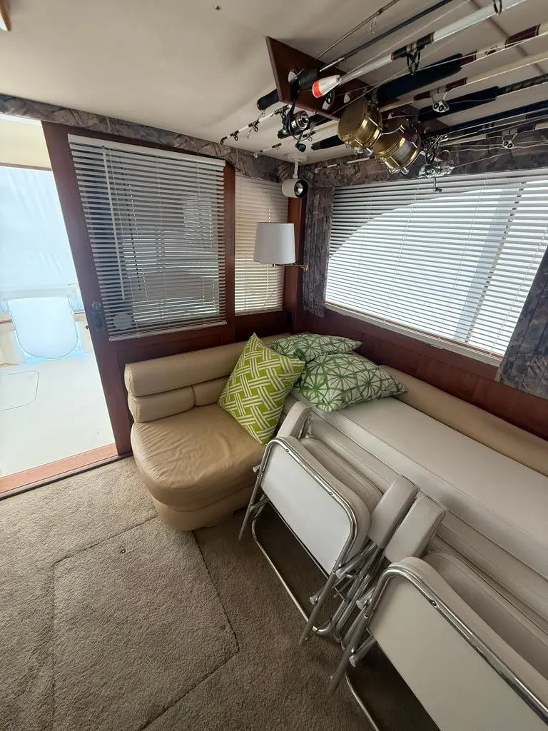 Slide: The Image of 1989 Post 43 Sport Fisherman interior with seating, fishing rods, and folded chairs. - 15