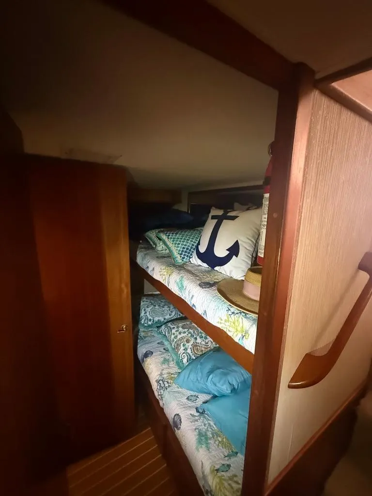 Slide: The Image of 1989 Post 43 Sport Fisherman cabin with cozy bunk beds and nautical-themed decor. - 18