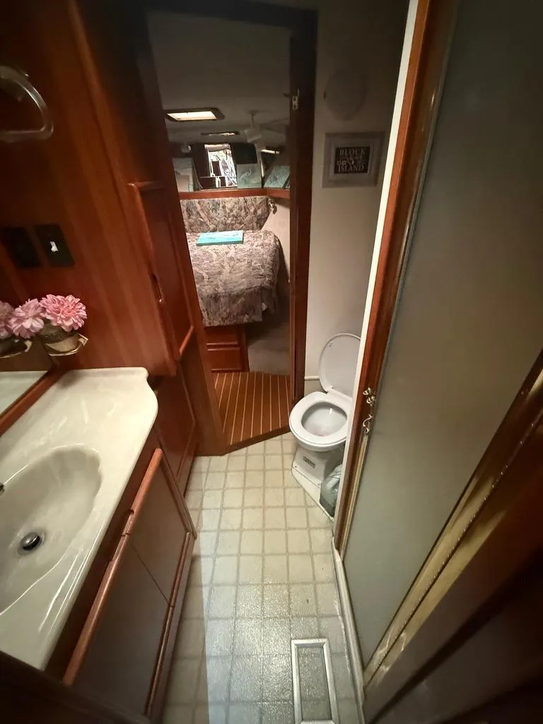 Slide: The Image of 1989 Post 43 Sport Fisherman bathroom with sink, toilet, and view into cabin. - 19