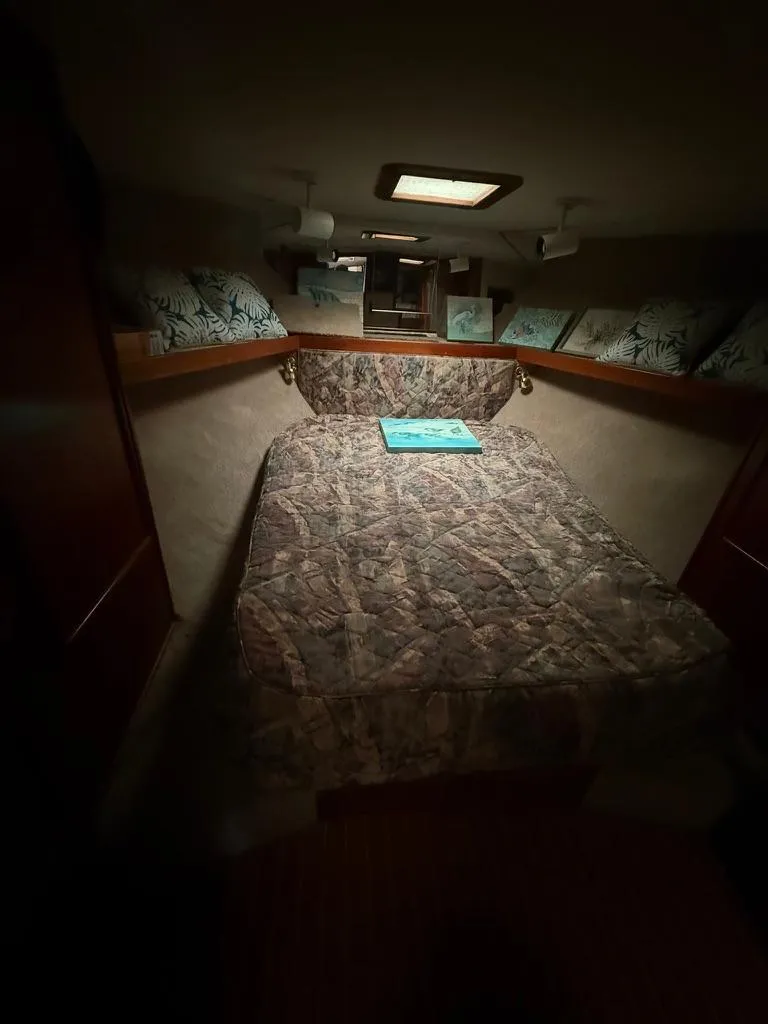 Slide: The Image of 1989 Post 43 Sport Fisherman cabin with bed, pillows, and overhead light. - 20