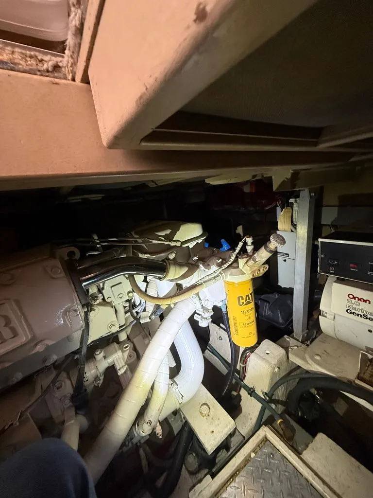 Slide: The Image of Engine room of 1989 Post 43 Sport Fisherman boat with visible CAT filter and Onan generator. - 21