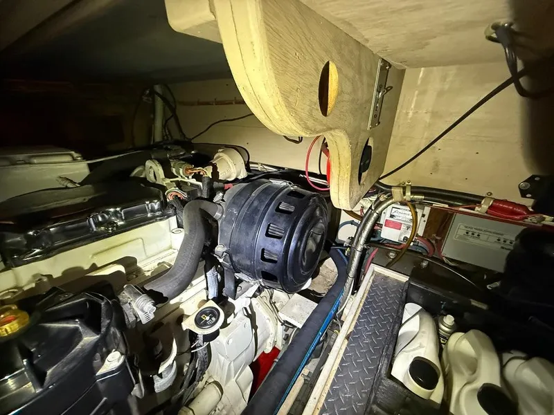 Slide: The Image of Engine room of a 1989 Post 43 Sport Fisherman boat, showcasing mechanical components. - 25