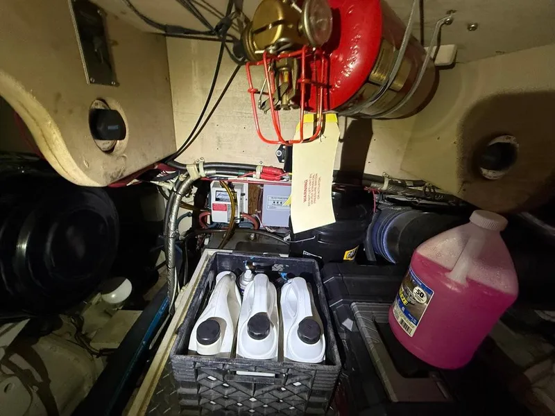 Slide: The Image of Engine room of 1989 Post 43 Sport Fisherman with maintenance supplies and fire extinguisher. - 26