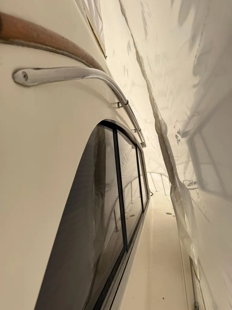 Slide: The Image of 1989 Post 43 Sport Fisherman yacht side view under protective cover. - 6