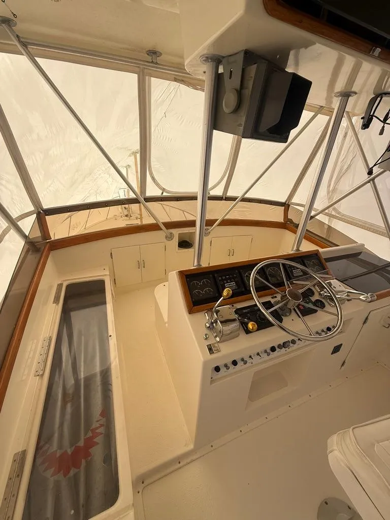 Slide: The Image of 1989 Post 43 Sport Fisherman boat interior with steering wheel and control panel. - 8