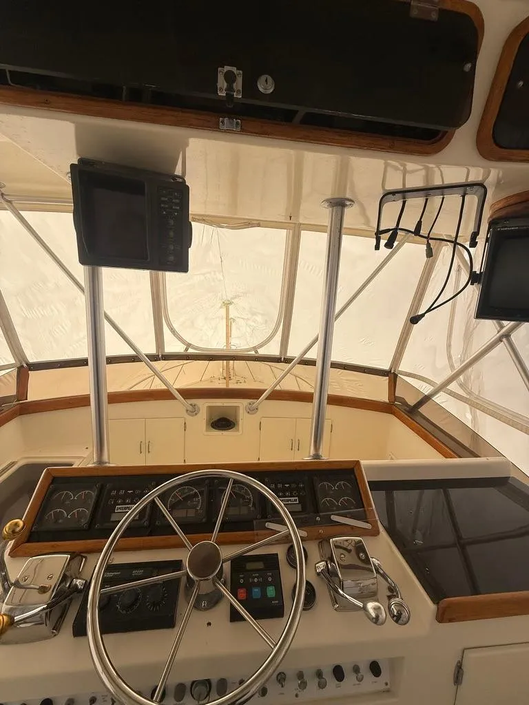Slide: The Image of 1989 Post 43 Sport Fisherman helm with steering wheel and navigation equipment. - 9