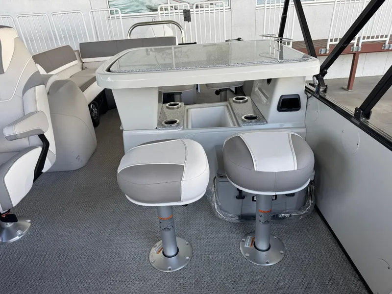 Slide: The Image of 2025 Avalon Catalina Entertainer boat interior with seating and table setup. - 11