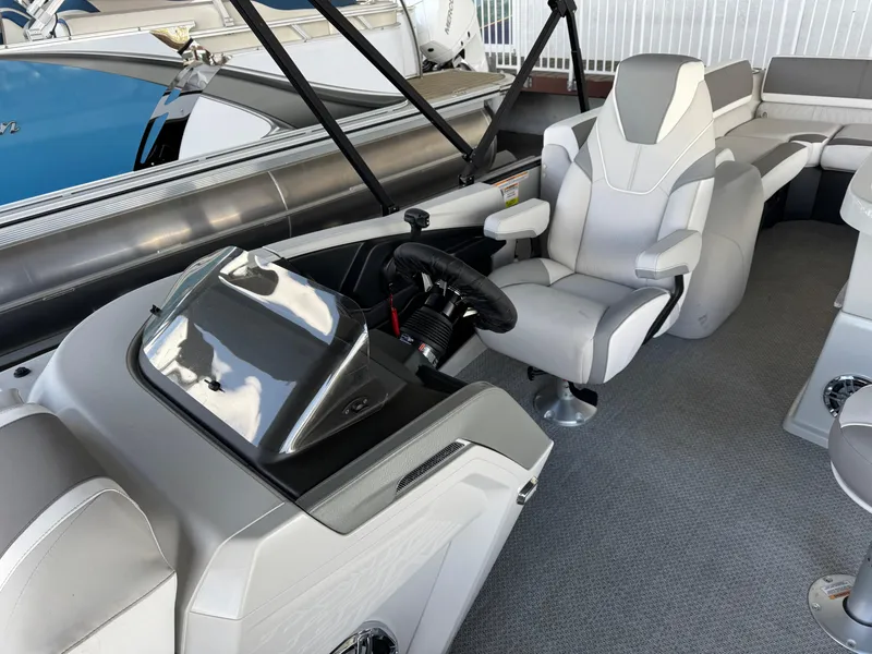 Slide: The Image of 2025 Avalon Catalina Entertainer 27' boat interior with modern helm and seating. - 13