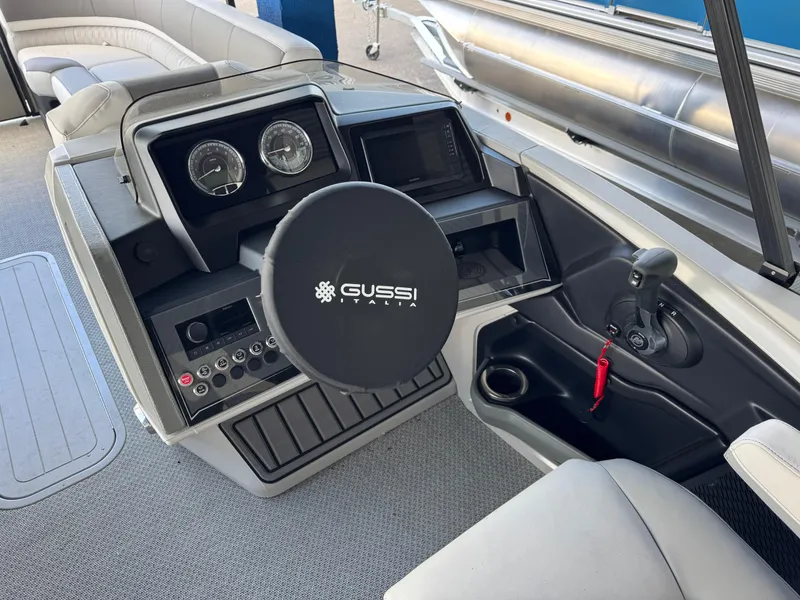 Slide: The Image of 2025 Avalon Catalina Entertainer boat dashboard with Gussi Italia steering wheel. - 16