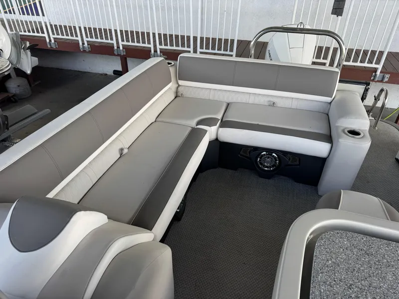 Slide: The Image of 2025 Avalon Catalina Entertainer 27' boat interior with gray and white seating. - 18