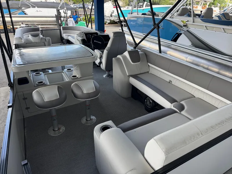 Slide: The Image of 2025 Avalon Catalina Entertainer 27' pontoon boat interior with seating and table. - 21