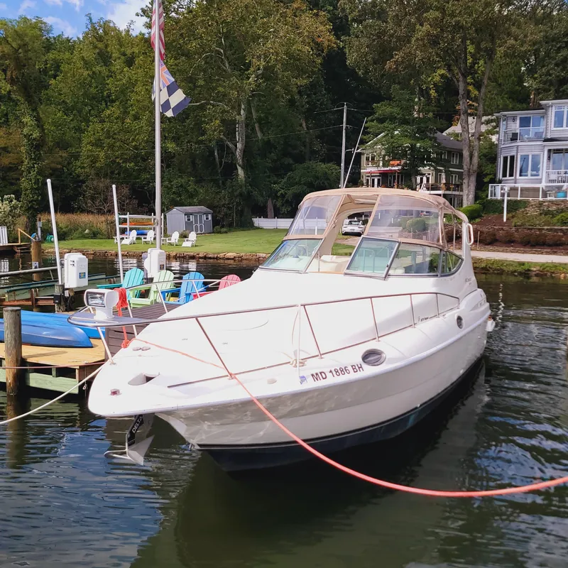 Slide: The Image of 1999 Cruisers Yachts 3075 Rogue docked by waterfront homes. - 12