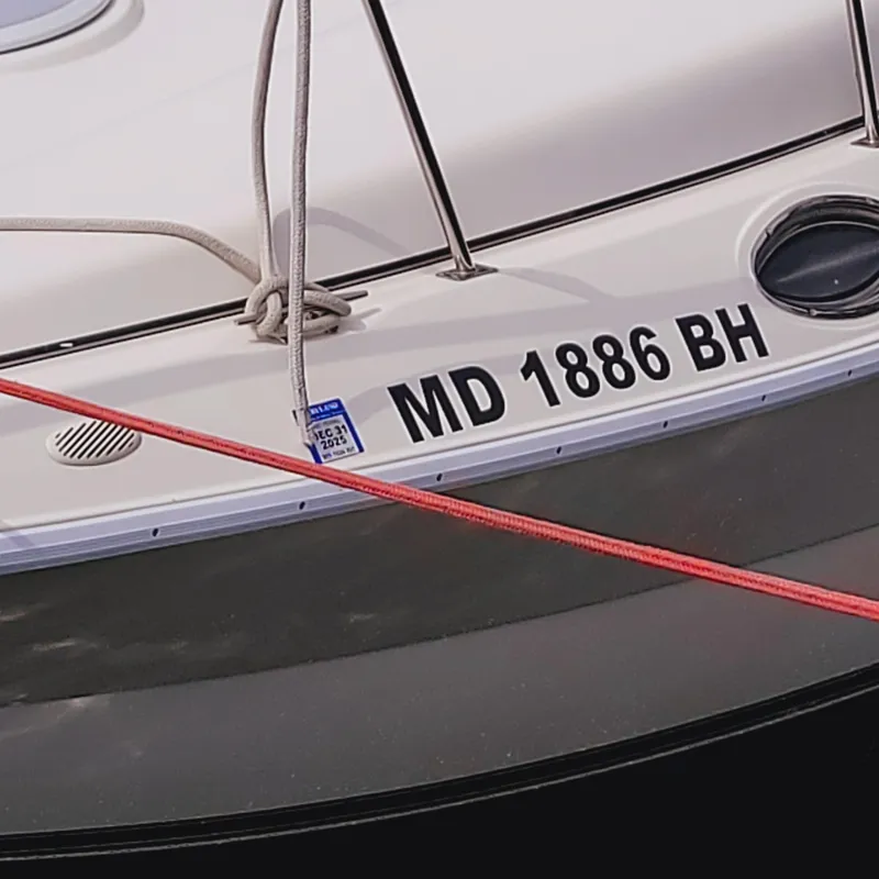 Slide: The Image of 1999 Cruisers Yachts 3075 Rogue with registration MD 1886 BH, docked with ropes. - 14