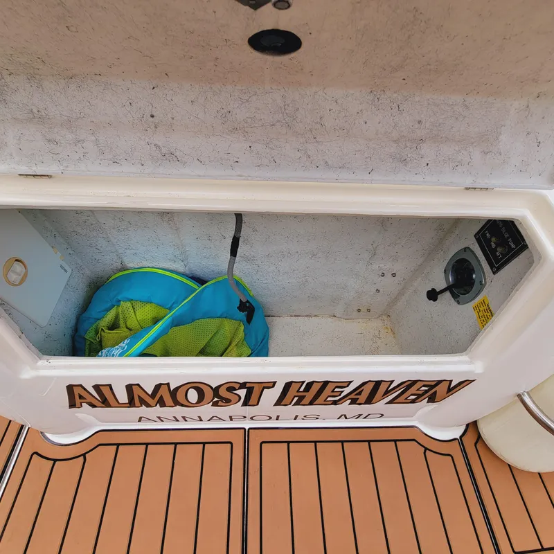 Slide: The Image of 1999 Cruisers Yachts 3075 Rogue storage compartment labeled "Almost Heaven," Annapolis, MD. - 18