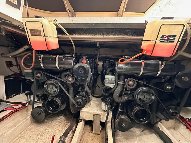 Slide: The Image of Engine room of a 1999 Cruisers Yachts 3075 Rogue, showcasing dual engines and components. - 2