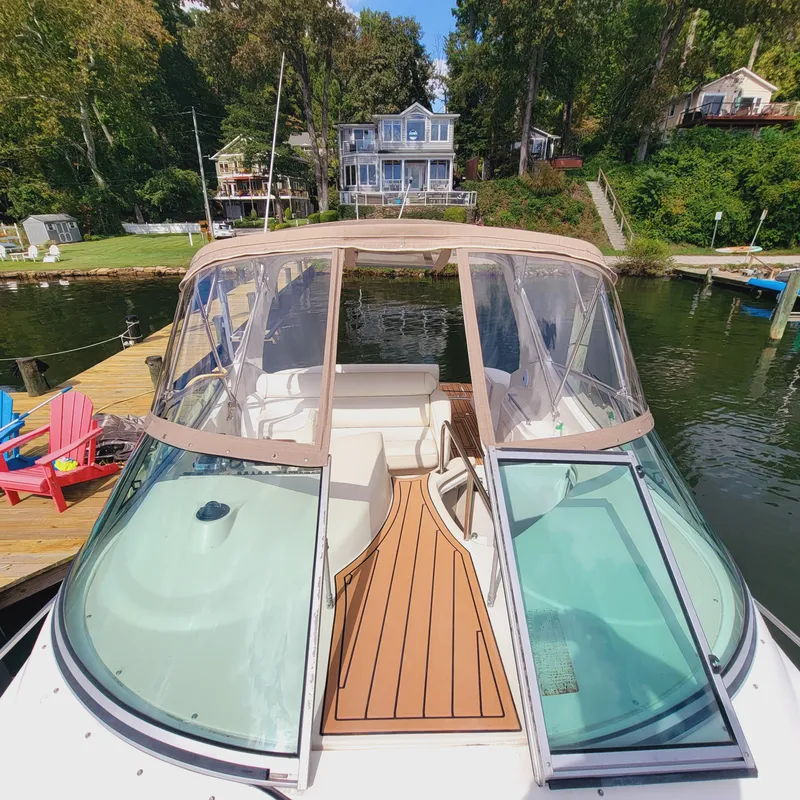 Slide: The Image of 1999 Cruisers Yachts 3075 Rogue docked near waterfront homes. - 31