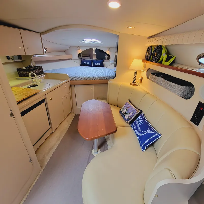 Slide: The Image of 1999 Cruisers Yachts 3075 Rogue interior with cozy seating, kitchenette, and sleeping area. - 33