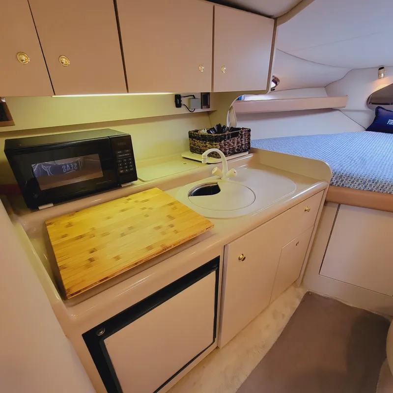 Slide: The Image of 1999 Cruisers Yachts 3075 Rogue interior with kitchenette and bed. - 34