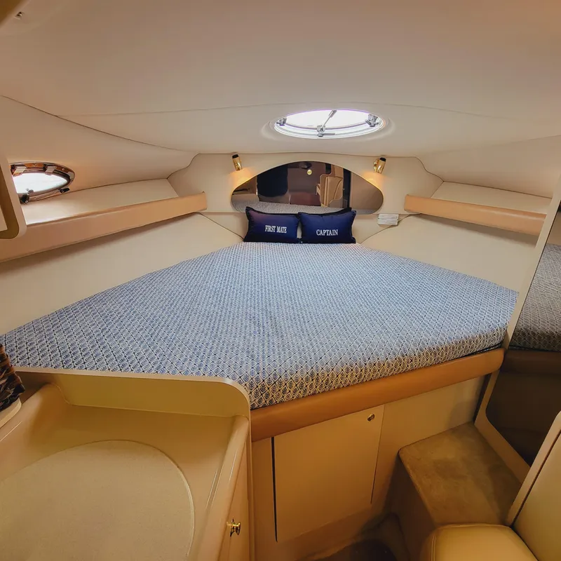 Slide: The Image of 1999 Cruisers Yachts 3075 Rogue cabin interior with bed and porthole. - 35