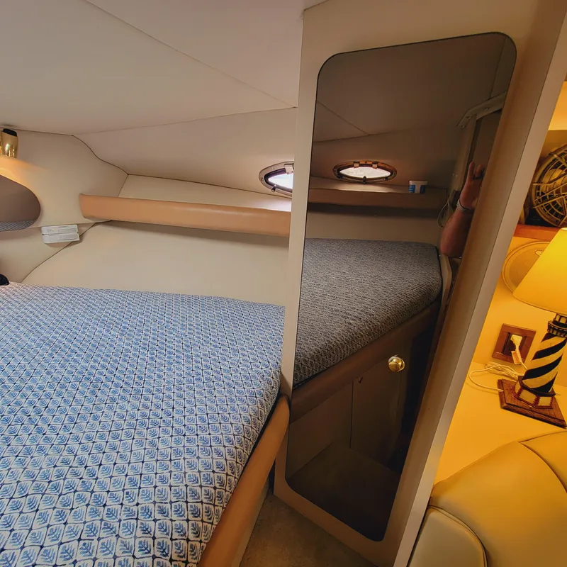 Slide: The Image of 1999 Cruisers Yachts 3075 Rogue cabin interior with bed, mirror, and nautical decor. - 36