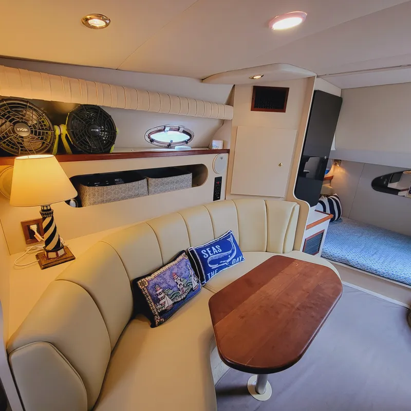 Slide: The Image of Interior of 1999 Cruisers Yachts 3075 Rogue with cozy seating and nautical decor. - 37
