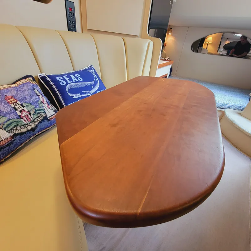 Slide: The Image of 1999 Cruisers Yachts 3075 Rogue interior with wooden table and cushioned seating. - 38