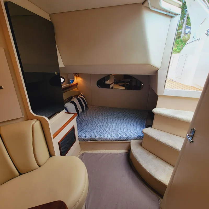 Slide: The Image of Interior of 1999 Cruisers Yachts 3075 Rogue, featuring cozy cabin and seating area. - 43