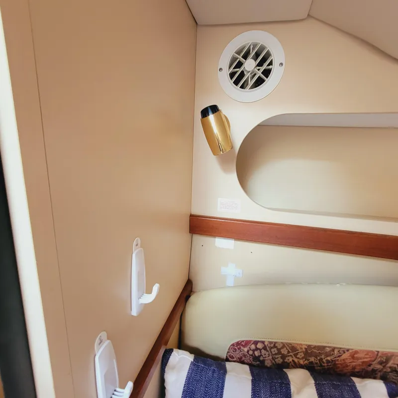 Slide: The Image of 1999 Cruisers Yachts 3075 Rogue cabin interior with beige walls and striped cushions. - 45