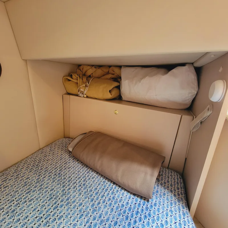 Slide: The Image of 1999 Cruisers Yachts 3075 Rogue cabin interior with bedding and storage. - 46