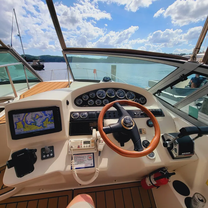 Slide: The Image of 1999 Cruisers Yachts 3075 Rogue helm with navigation system and wooden steering wheel. - 5