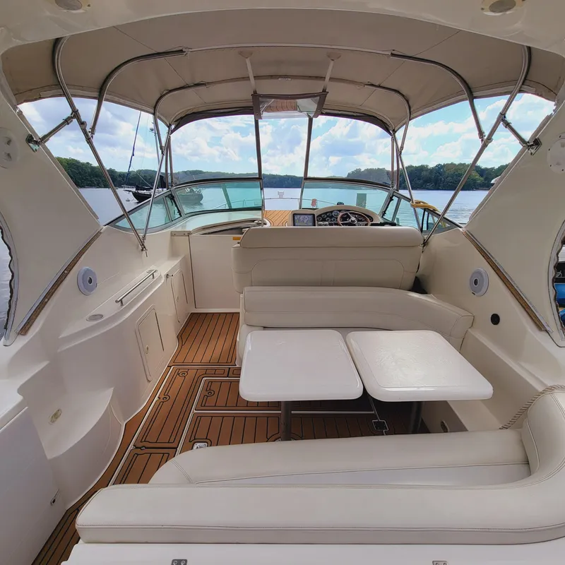 Slide: The Image of 1999 Cruisers Yachts 3075 Rogue interior with white seating and wooden flooring. - 6